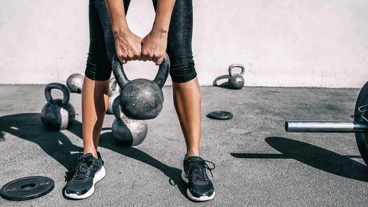 Closeup of a woman doing lifting in gym